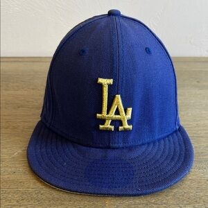 New Era Los Angeles Dodgers Navy Blue Fitted Hat with Gold LA Logo. Adjustable.